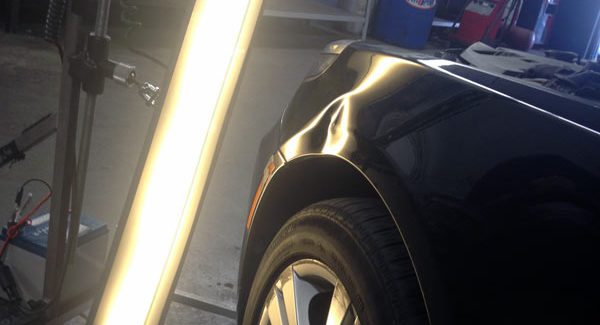 Dent light on BMW fender.